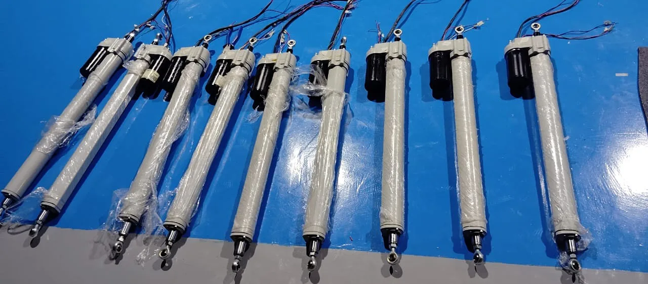 Production batch of Dreamfusion linear actuators laid out on a blue bench